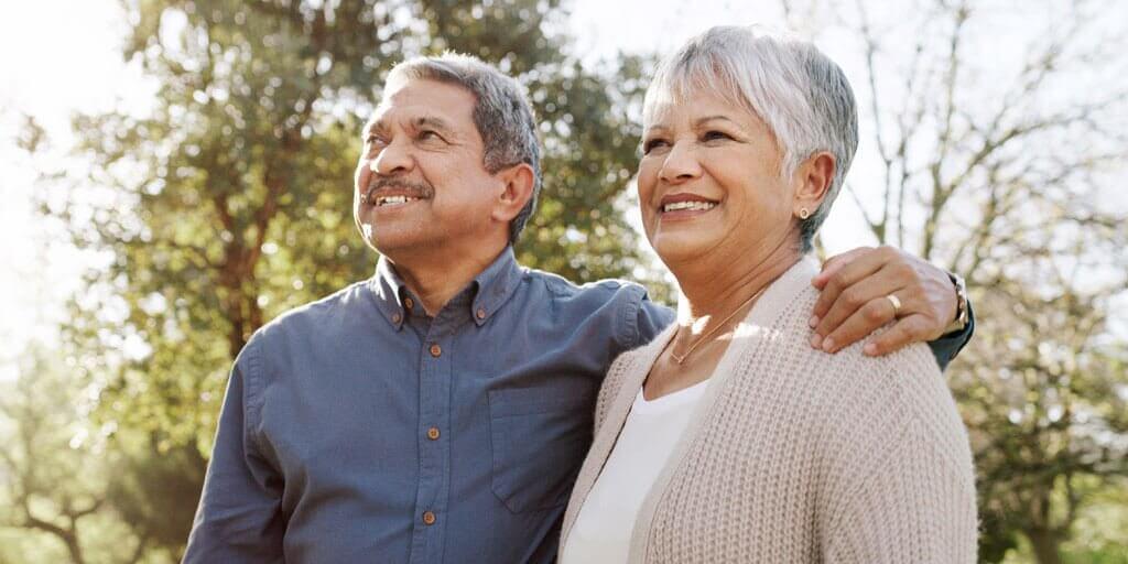 about-the-cornea-1024x512 A senior couple is standing outdoors admiring the view.